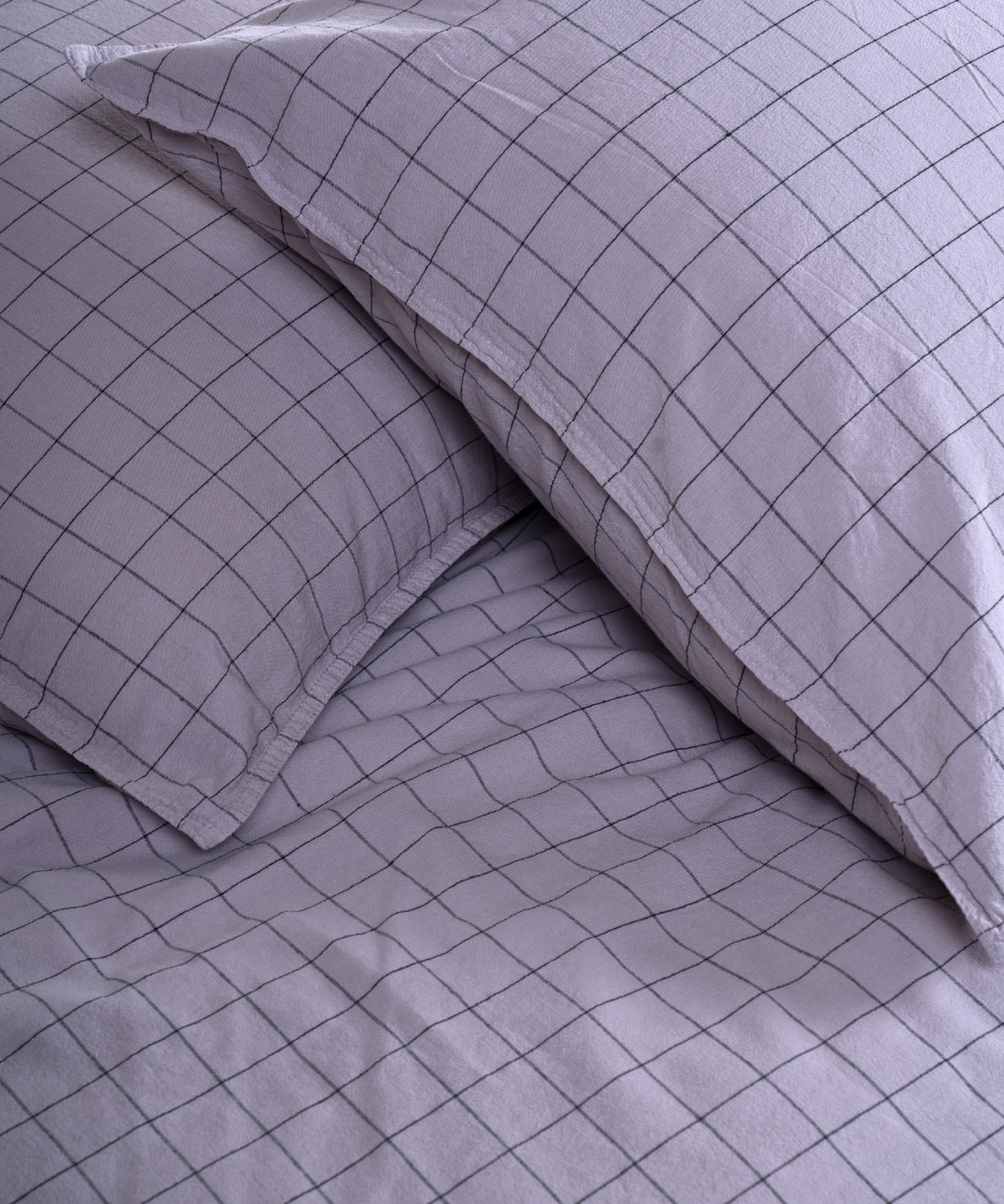 Close-up of stonewashed 100% cotton fabric texture in Natural Violet colour with soft relaxed finish